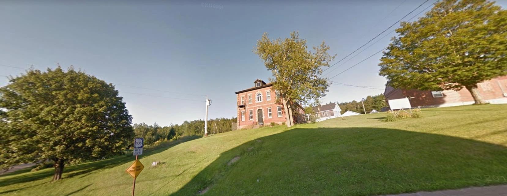 The historic red-brick Dorchester Jail on its grassy hillside